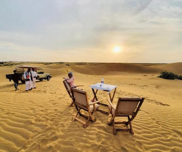 Private sundowner picnic on the dunes at golden hour